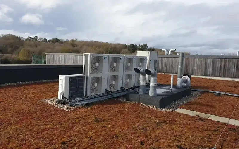 Cluster of outdoor air conditioning condensers on a green roof